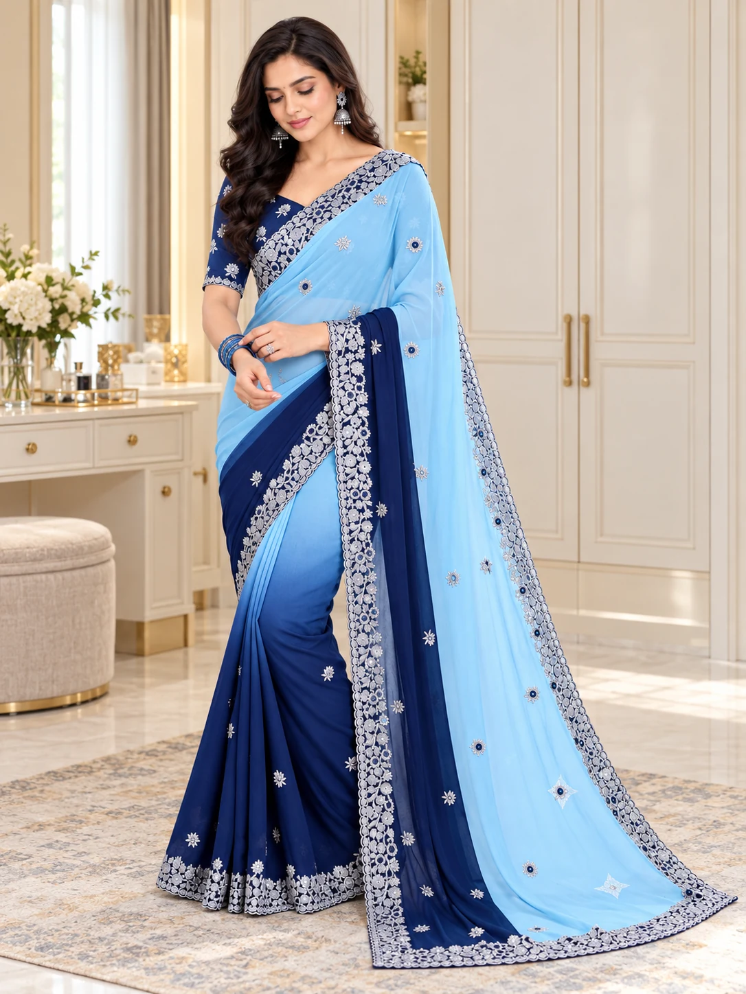 Sky-blue saree with a contrasting navy floral border, worn by a model